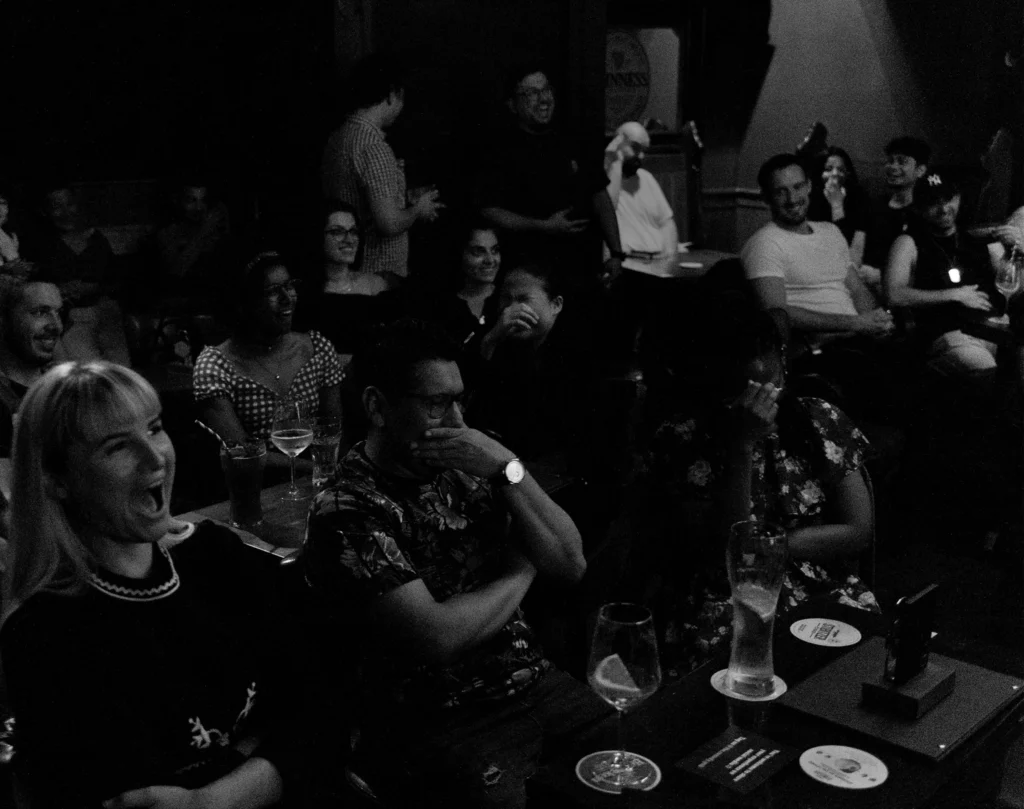 Audience laughing during a live comedy show at The Comedy Pub Vienna