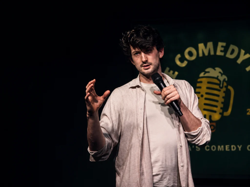Company team laughing during a corporate comedy event in Vienna